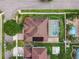 Aerial view of backyard with screened pool, solar panels, and lush greenery in a well-maintained yard at 14003 Sobrado Dr, Orlando, FL 32837