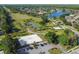 Aerial shot shows tennis and basketball courts along with a beach volleyball court adjacent to lake at 14003 Sobrado Dr, Orlando, FL 32837