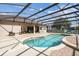 Stunning screened pool offers a spacious deck and an outdoor grill, perfect for entertaining and enjoying the outdoors at 14003 Sobrado Dr, Orlando, FL 32837