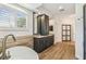 Bright bathroom features a soaking tub, granite countertop, and dark cabinets at 14003 Sobrado Dr, Orlando, FL 32837