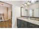 Bathroom features a granite vanity, wood floors and a large mirror at 14003 Sobrado Dr, Orlando, FL 32837