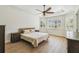 Bright bedroom featuring tile floors, a ceiling fan, and bright windows with plantation shutters at 14003 Sobrado Dr, Orlando, FL 32837