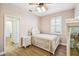 Bedroom featuring hardwood floors, ceiling fan, and an ensuite bathroom at 14003 Sobrado Dr, Orlando, FL 32837