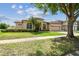 Inviting single-story home featuring lush landscaping and an attached two-car garage at 14003 Sobrado Dr, Orlando, FL 32837