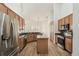 Kitchen featuring stainless steel appliances, granite countertops, and wood-look flooring at 14003 Sobrado Dr, Orlando, FL 32837