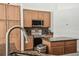 Well-lit kitchen with stainless steel appliances, granite countertops, and wood cabinets at 14003 Sobrado Dr, Orlando, FL 32837