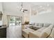 Expansive living room featuring an oversized sectional sofa and sliding glass doors to the pool area at 14003 Sobrado Dr, Orlando, FL 32837