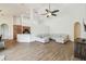 Bright living room features an oversized sectional sofa, hardwood floors, and an open layout to the kitchen at 14003 Sobrado Dr, Orlando, FL 32837
