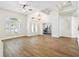 Bright and spacious living room featuring wood flooring, tray ceilings, and modern light fixture at 14003 Sobrado Dr, Orlando, FL 32837