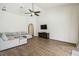 Inviting living room with a neutral sectional sofa, high ceilings, and hardwood floors for a comfortable living space at 14003 Sobrado Dr, Orlando, FL 32837