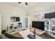 Spacious office with modern desk, hardwood floors, built-in shelving, and abundant lighting for a functional workspace at 14003 Sobrado Dr, Orlando, FL 32837