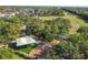 An aerial view of the community park featuring a playground, canopy, and walkways, surrounded by mature trees and lush landscaping at 14003 Sobrado Dr, Orlando, FL 32837