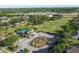 Overhead shot of community park with a playground, geometric topiary, sports field, and surrounding neighborhood at 14003 Sobrado Dr, Orlando, FL 32837