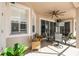 Charming covered patio with outdoor seating, an outdoor television, and views of the screened-in pool area at 14003 Sobrado Dr, Orlando, FL 32837