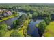 Aerial view of a community pond with lush green surrounding the area with walking path at 14003 Sobrado Dr, Orlando, FL 32837
