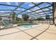 Lovely screened pool features a waterfall, ample deck space, and comfortable lounge chairs for relaxing by the water at 14003 Sobrado Dr, Orlando, FL 32837