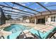 A screened-in pool area with lounge chairs and a seating area provides a relaxing outdoor space at 14003 Sobrado Dr, Orlando, FL 32837