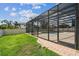 A screened pool area, patio, and green grass offer a delightful outdoor oasis at 14003 Sobrado Dr, Orlando, FL 32837
