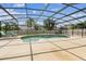 Beautiful screened pool featuring a waterfall feature and a large deck with lounge chairs, perfect for outdoor enjoyment at 14003 Sobrado Dr, Orlando, FL 32837