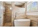 Bright bathroom showcases a soaking tub and a walk-in shower with dual shower heads at 14003 Sobrado Dr, Orlando, FL 32837