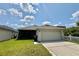 Charming home featuring a 2-car garage, screened in porch, and a well manicured lawn at 14479 Tanja King Blvd, Orlando, FL 32828