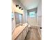 Well-lit bathroom featuring a tub with white tile surround and large vanity with storage at 14479 Tanja King Blvd, Orlando, FL 32828