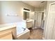 The bathroom features a soaking tub, walk-in shower, and vanity with ample storage at 14479 Tanja King Blvd, Orlando, FL 32828