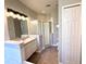 Bathroom featuring a large vanity with a sink, a walk-in shower, and a toilet at 14479 Tanja King Blvd, Orlando, FL 32828