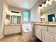 This bathroom features double sinks with a soaking tub between, and a window for natural light at 14479 Tanja King Blvd, Orlando, FL 32828