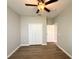 Bedroom featuring wood-look flooring, a closet, ceiling fan, and neutral walls at 14479 Tanja King Blvd, Orlando, FL 32828