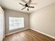 Bedroom featuring a ceiling fan and a window for natural light, with wood-look flooring at 14479 Tanja King Blvd, Orlando, FL 32828