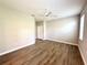 This bedroom features wood-look flooring, a ceiling fan, neutral paint, and ample natural light at 14479 Tanja King Blvd, Orlando, FL 32828