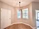 Cozy dining area with tile flooring, a modern light fixture, and views of the outdoors at 14479 Tanja King Blvd, Orlando, FL 32828