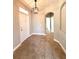 Inviting foyer featuring neutral paint, decorative light fixture, and beautiful tile flooring at 14479 Tanja King Blvd, Orlando, FL 32828