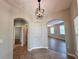 Inviting foyer with tiled floor, decorative lighting, and arched doorways at 14479 Tanja King Blvd, Orlando, FL 32828
