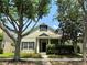 Charming single-Gathering home with mature trees, lush landscaping, and inviting curb appeal at 14479 Tanja King Blvd, Orlando, FL 32828