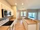 Open kitchen layout with stainless steel appliances, tile floors, and a view of the dining area at 14479 Tanja King Blvd, Orlando, FL 32828