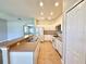 Well-lit kitchen with white cabinets, stainless steel appliances, tile flooring, and breakfast bar at 14479 Tanja King Blvd, Orlando, FL 32828