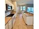Clean kitchen showcasing stainless steel appliances, tile flooring, and open layout to the dining area at 14479 Tanja King Blvd, Orlando, FL 32828