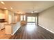 Open living area with wood laminate flooring, ceiling fan, and sliding glass door to the backyard at 14479 Tanja King Blvd, Orlando, FL 32828