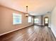 Open-concept living space featuring lots of natural light and laminate wood flooring at 14479 Tanja King Blvd, Orlando, FL 32828