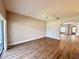 Spacious living room featuring laminate wood flooring, arched doorway and sliding glass doors at 14479 Tanja King Blvd, Orlando, FL 32828