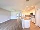 Open-concept living space featuring tile and wood laminate flooring connecting the kitchen and living areas at 14479 Tanja King Blvd, Orlando, FL 32828