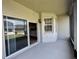 Covered patio with a sliding glass door and space for outdoor seating at 14479 Tanja King Blvd, Orlando, FL 32828