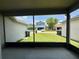 Screened-in patio with a view of the green lawn and neighboring house at 14479 Tanja King Blvd, Orlando, FL 32828