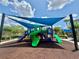 A community playground featuring slides, climbing areas, and a protective sunshade for children to enjoy at 14479 Tanja King Blvd, Orlando, FL 32828