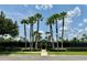 Well-maintained tennis courts with tall palm trees, providing a perfect setting for active community recreation at 14479 Tanja King Blvd, Orlando, FL 32828