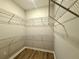 The walk-in closet features wire shelving all around, with wood-look flooring at 14479 Tanja King Blvd, Orlando, FL 32828