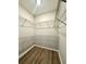 This walk-in closet includes wood look floors and wire shelving for ample storage at 14479 Tanja King Blvd, Orlando, FL 32828