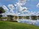 Beautiful water view with a fountain and residences, reflecting clouds under a sunny sky at 14479 Tanja King Blvd, Orlando, FL 32828